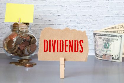 Small sign reading "dividends" sitting on a desk.