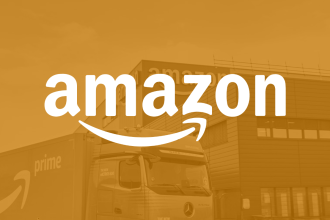 Amazon name on yellow screen filter with warehouse and truck in background.