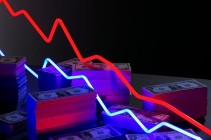Chart lines going down over a pile of cash.