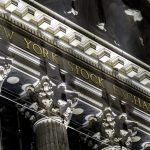 A January 2021 documentary photograph of the New York Stock Exchange name and columns on Broad Street, used to illustrate the October 7, 2026 U.S. after-close market report.