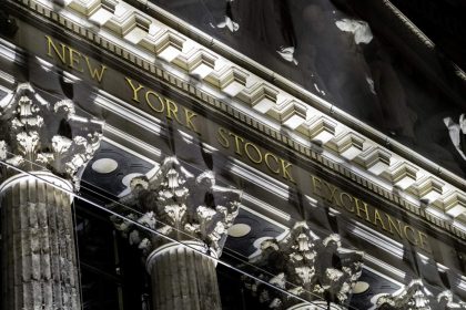 A January 2021 documentary photograph of the New York Stock Exchange name and columns on Broad Street, used to illustrate the October 7, 2026 U.S. after-close market report.